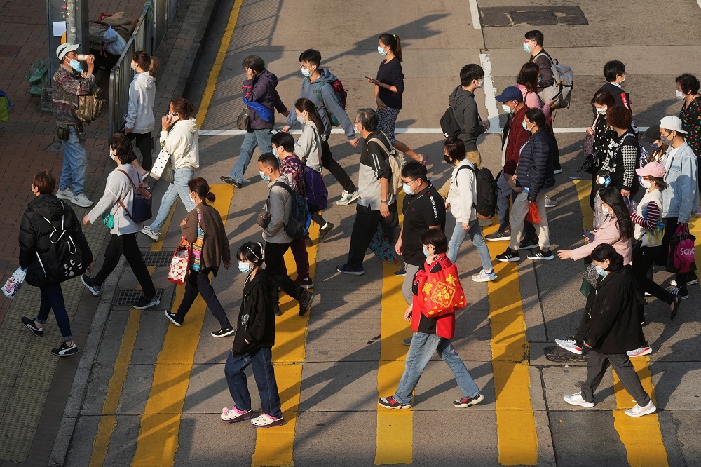 People wearing face masks cross a street following the coronavirus disease outbreak, in Hong Kong February 15, 2022. u00e2u20acu201d Reuters pic