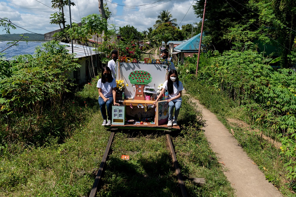 Student volunteers ride on their makeshift trolley which serves as a mobile library for children, in Tagkawayan, Quezon Province, Philippines February 15, 2022. u00e2u20acu201d Reuters pic