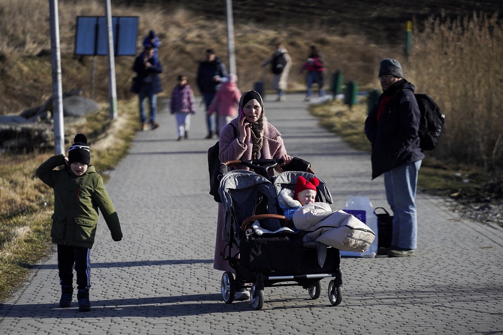 A family arrives at the Polish border crossing after fleeing violence in Ukraine, in Medyka, Poland February 24, 2022. u00e2u20acu201d Reuters pic