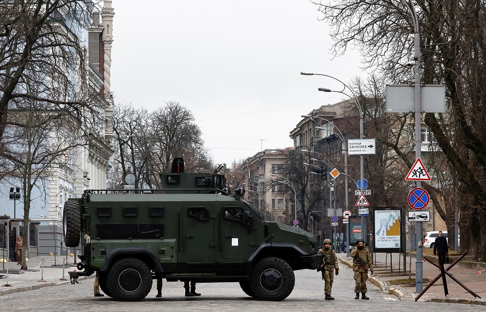 Ukrainian military service members guard a road that leads to a government block, after Russian President Vladimir Putin authorised a military operation in eastern Ukraine, in Kyiv, Ukraine February 24, 2022. u00e2u20acu201d Reuters pic