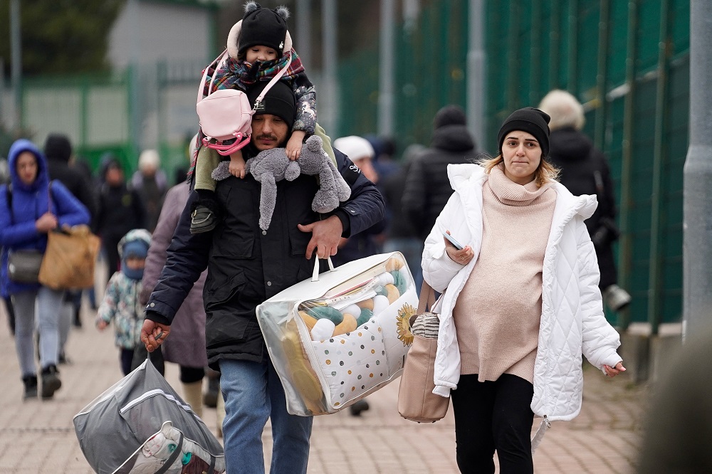 A family exits the border after crossing over to flee violence in Ukraine, in Medyka, Poland February 25, 2022. u00e2u20acu201d Reuters pic