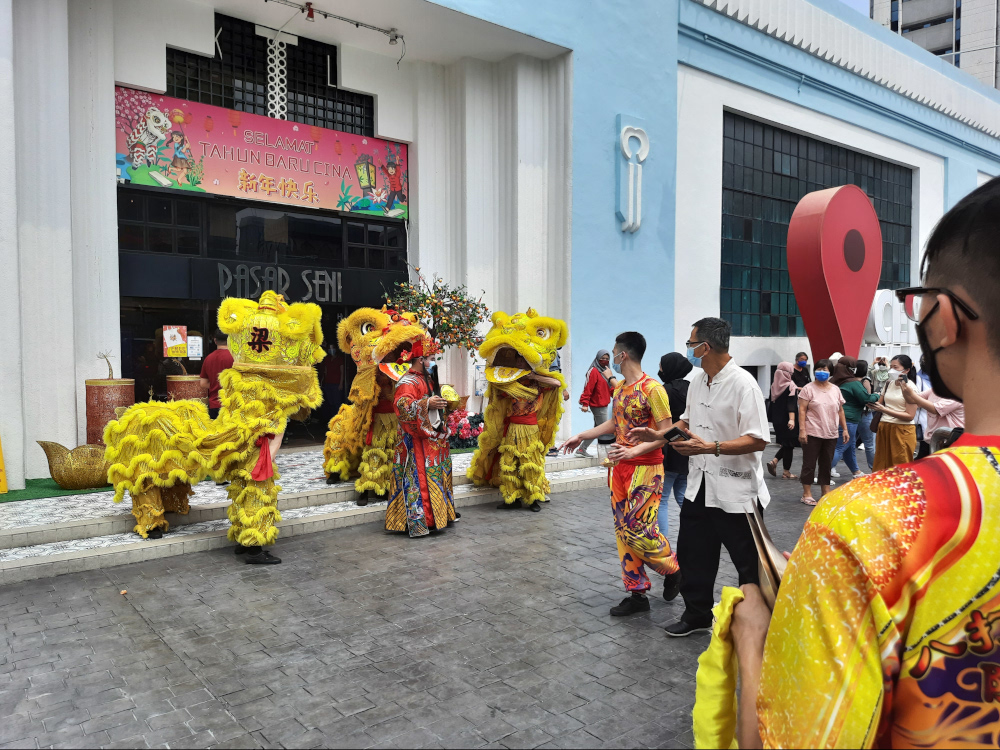 A lion dance troupe performing outside Pasar Seni, also known as Central Market, Kuala Lumpur at noon on the first day of Chinese New Year February 1. — Picture by Keertan Ayamany
