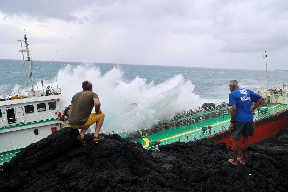 Pedestrians look at a Maurician oil tanker Tresta Star stranded on Tremblet coast in Saint-Philippe, after the passage of the tropical cyclone Batsirai as the island was placed under a cyclonic red alert, February 4, 2022. u00e2u20acu201d AFP pic