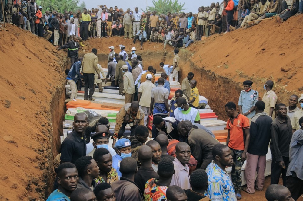 Civilians and Red Cross volunteers attend the burial of 62 displaced people who were massacred in the Plaine Savo IDP camp near Bule in Ituri province, northeastern Democratic Republic of Congo February 4, 2022. u00e2u20acu201d AFP pic