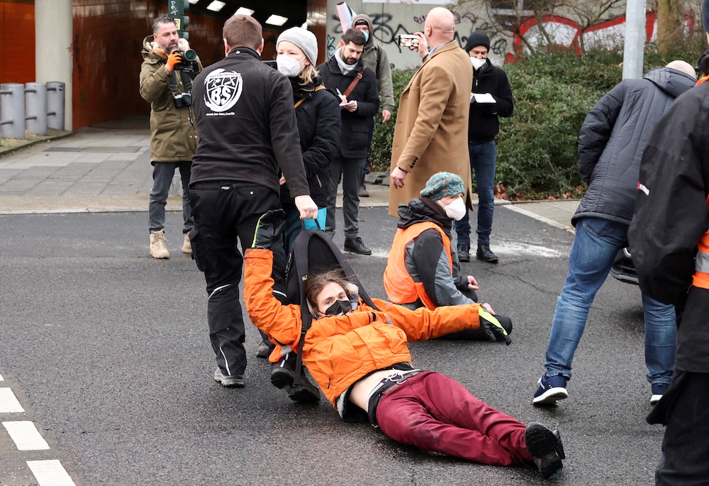 A u00e2u20acu02dcLetzte Generationu00e2u20acu2122 (Last Generation) activist is dragged by a man during a protest against food waste and for an agricultural change to reduce greenhouse gas emissions, in Berlin, Germany, February 7, 2022. u00e2u20acu201d Reuters picn n