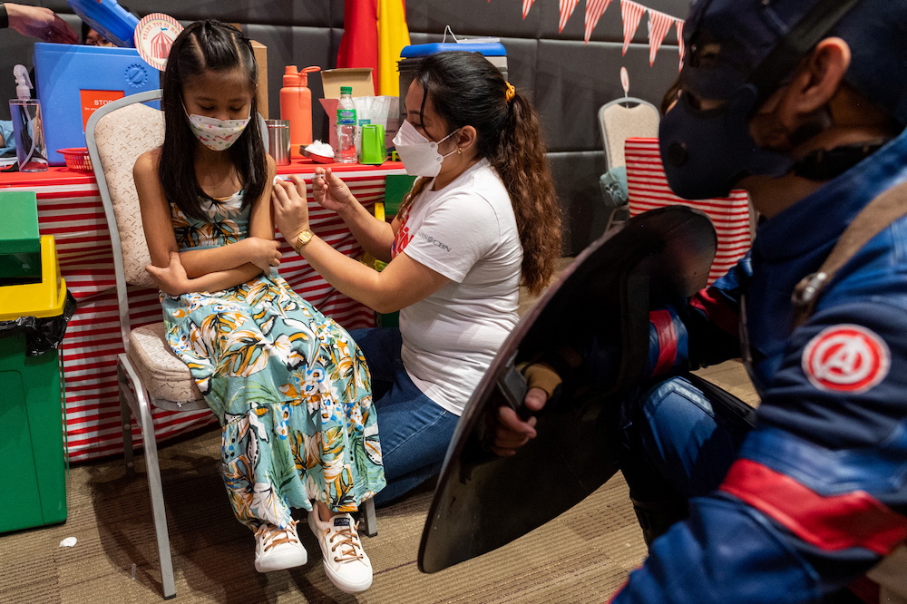 A child receives her first dose of Pfizer coronavirus disease (Covid-19) vaccine  during the vaccine rollout for children aged 5-11, at a mall in Taguig City, Metro Manila, Philippines, February 7, 2022.  u00e2u20acu201d Reuters picnn
