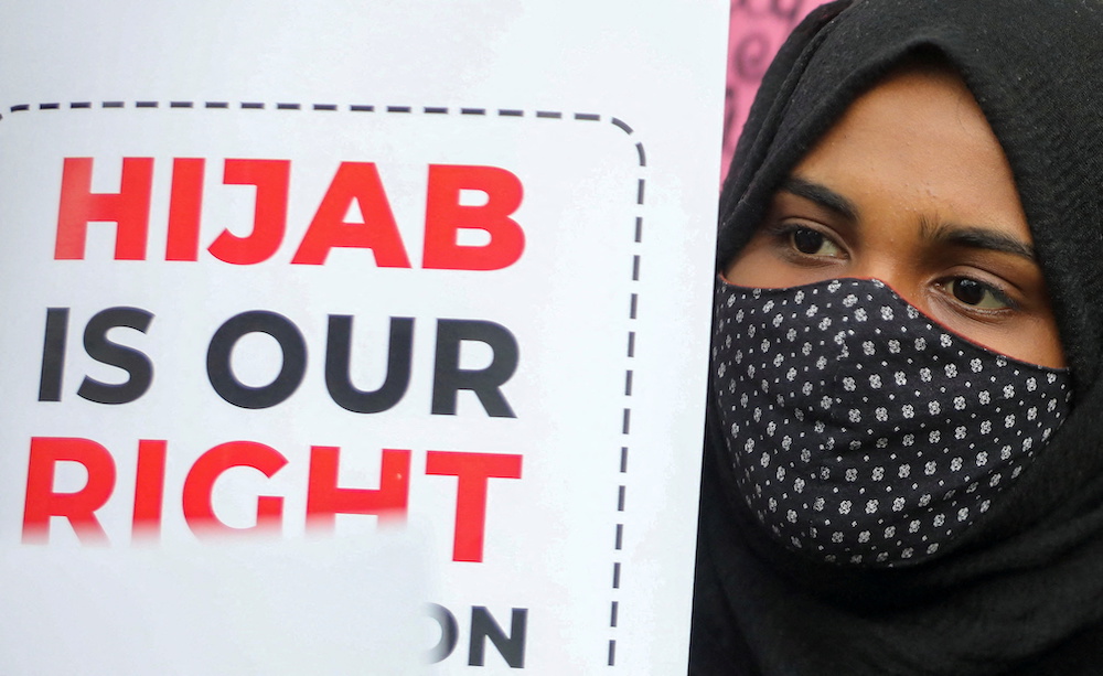 A Muslim student holds a placard during a protest by Muslim Students Federation (MSF) against the recent hijab ban in few of Karnatakau00e2u20acu2122s colleges, in New Delhi, India, February 8, 2022. u00e2u20acu201d Reuters pic