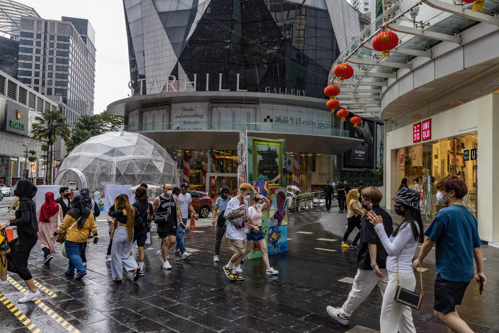 People are seen wearing protective masks as they walk along the Bukit Bintang shopping area in Kuala Lumpur February 13, 2022. u00e2u20acu201d Picture by Firdaus Latif