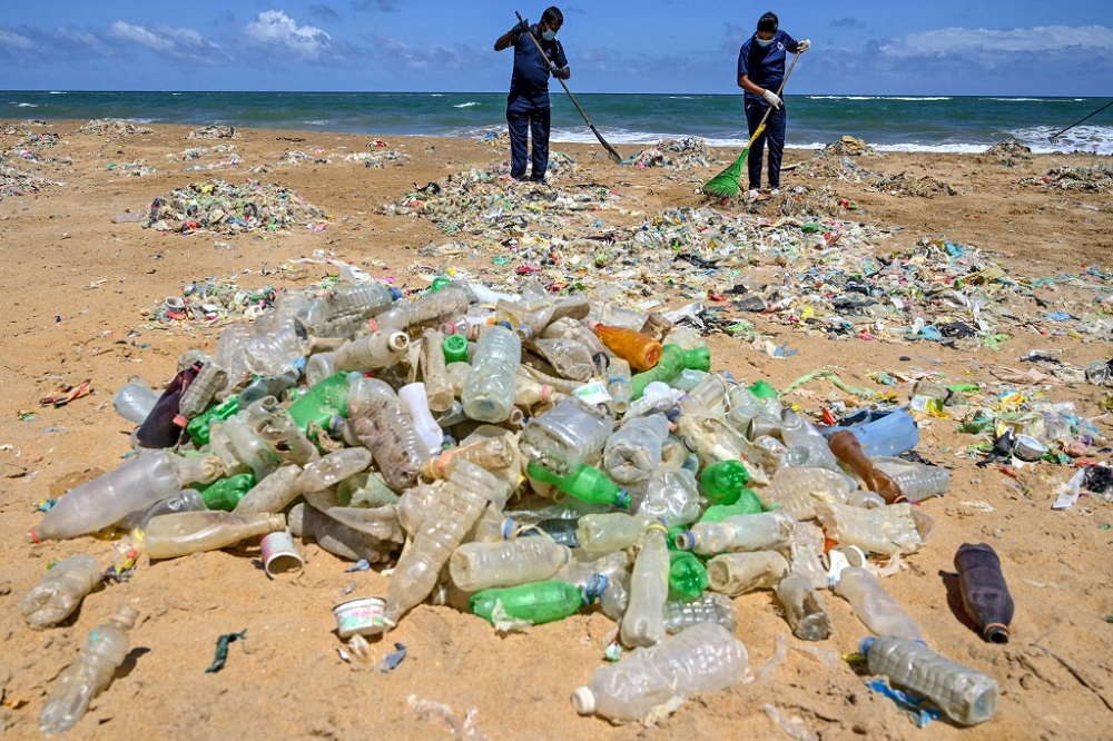 Police Environmental Protection Division officers take part in a beach clean-up effort to remove waste and garbage at Mount Lavinia on the outskirts of Colombo in this file photo taken June 5, 2020. — AFP pic