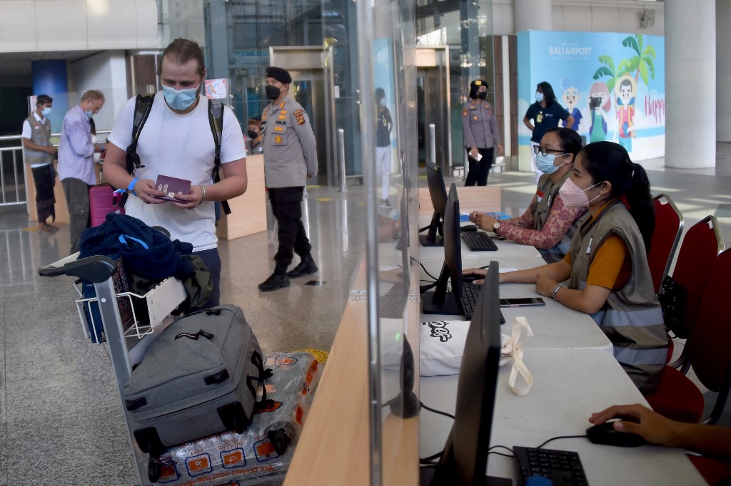 Travellers are processed at the international arrivals hall at Ngurah Rai International Airport in Tuban near Denpasar on Indonesia's resort island of Bali on February 16, 2022. u00e2u20acu201d AFP picnn
