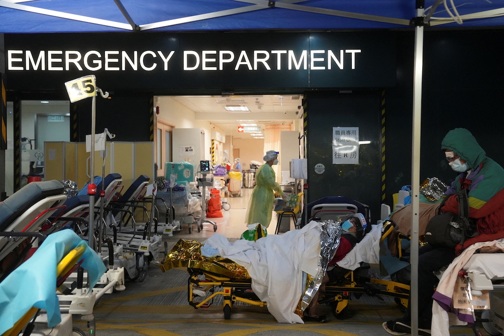 A patient wearing a face mask and a face shield lies on a beds at a makeshift treatment area outside a hospital, following the coronavirus disease (Covid-19) outbreak in Hong Kong, China February 17, 2022. u00e2u20acu201d Reuters picnn