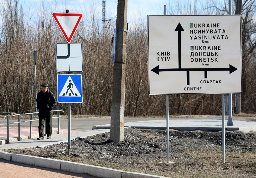 A man walks past a road sign in the town of Avdiivka, Donetsk region, located on the front-line with Russia backed separatists on February 21, 2022. u00e2u20acu201d AFP pic