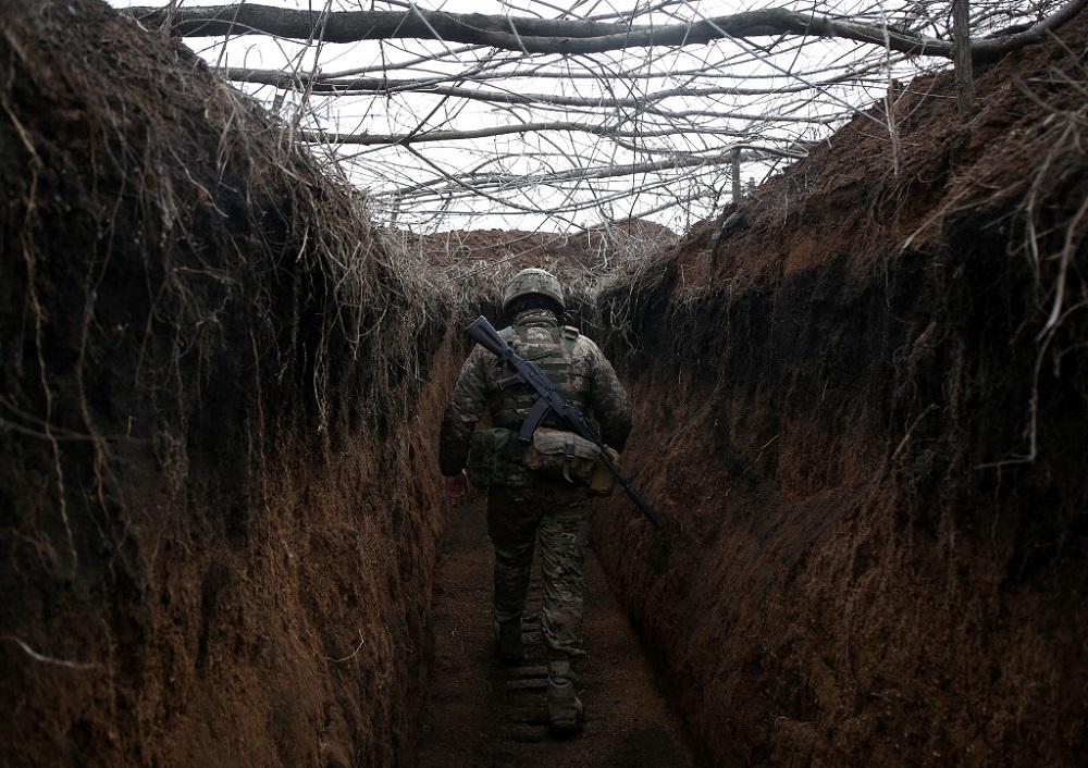 A serviceman of Ukrainian Military Forces walks along trench on his position on the front line with Russia backed separatists not far Novolugansk, Donetsk region February 16, 2022. u00e2u20acu201d AFP pic