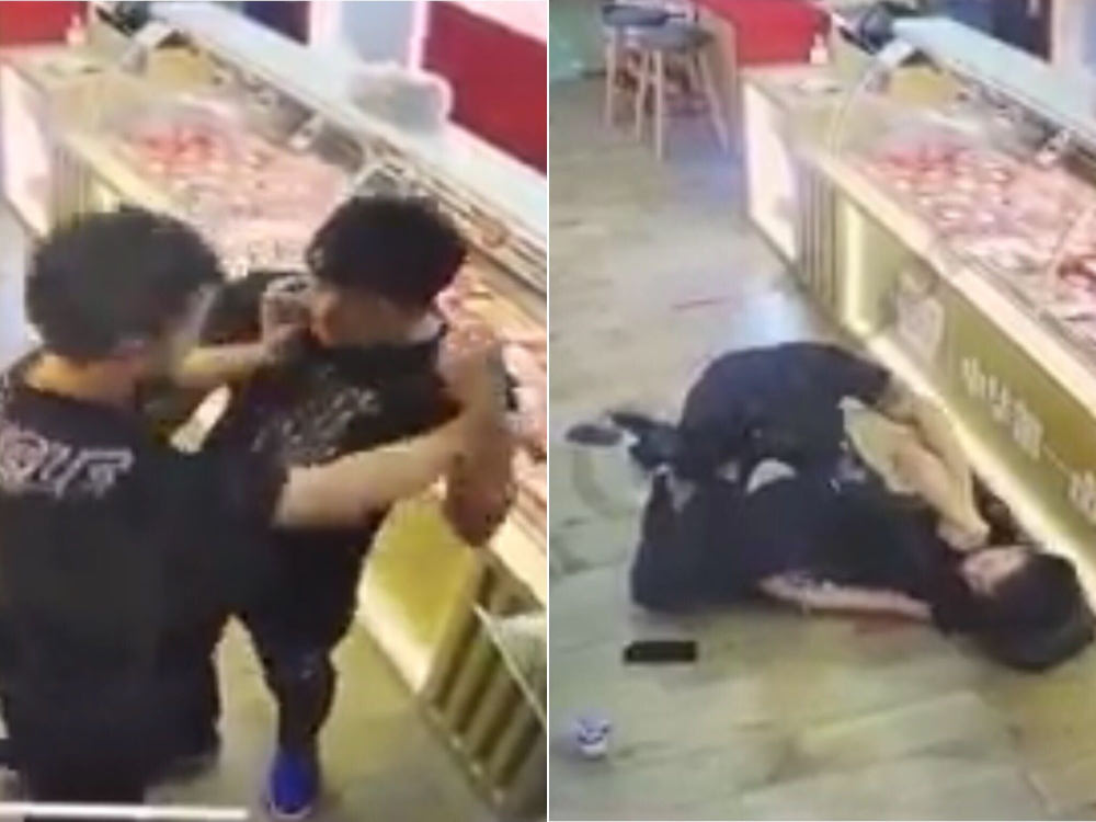 Screenshots from a video posted on Facebook show two men getting into a fight at a store. u00e2u20acu201d Picture via Facebook/Beh Chia Lor u00e2u20acu201d Singapore Road
