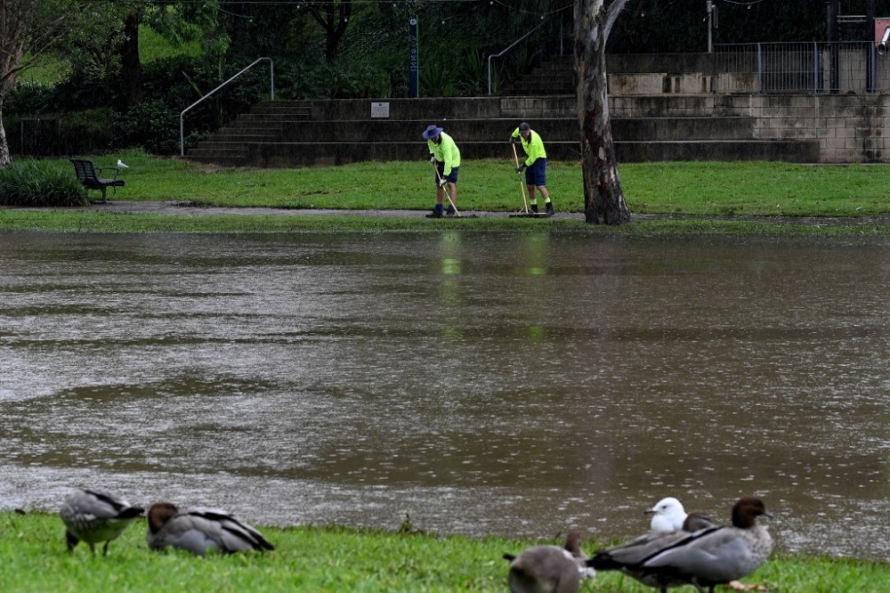 Workers clear water from the banks of the overflowing Parramatta river in Sydney February 23, 2022. u00e2u20acu201d AFP pic