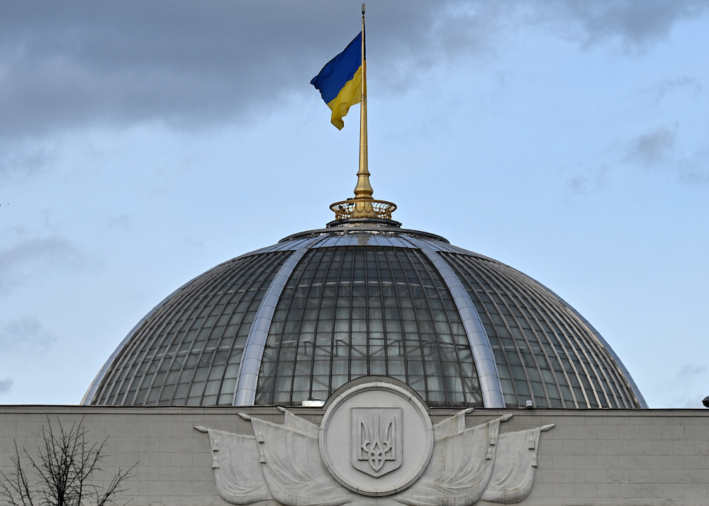 This photograph taken on February 23, 2022 shows the Ukrainian the flag fluttering above the dome of the parliament in Kyiv. u00e2u20acu201d AFP pic