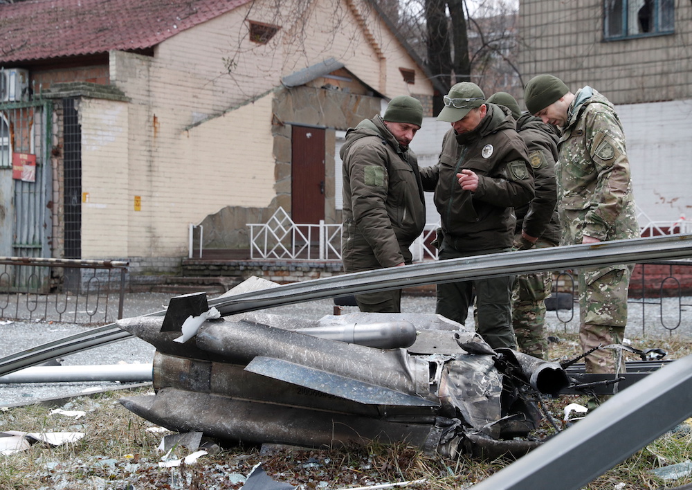 Police officers inspect the remains of a missile that fell in the street, after Russian President Vladimir Putin authorized a military operation in eastern Ukraine, in Kyiv, Ukraine February 24, 2022. u00e2u20acu201d Reuters pic