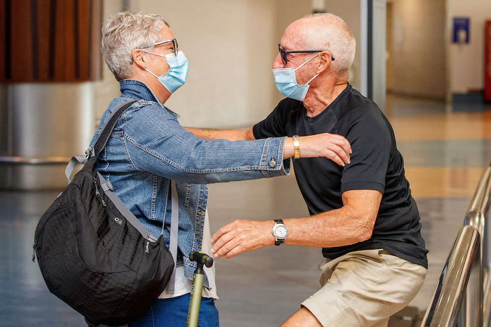 Passengers and loved ones reunite at the arrivals hall on the first day of New Zealanders returning from Australia after the border reopened for travellers observing home self-isolation rules, at the Auckland international airport on February 28, 2022. u00e2u20ac