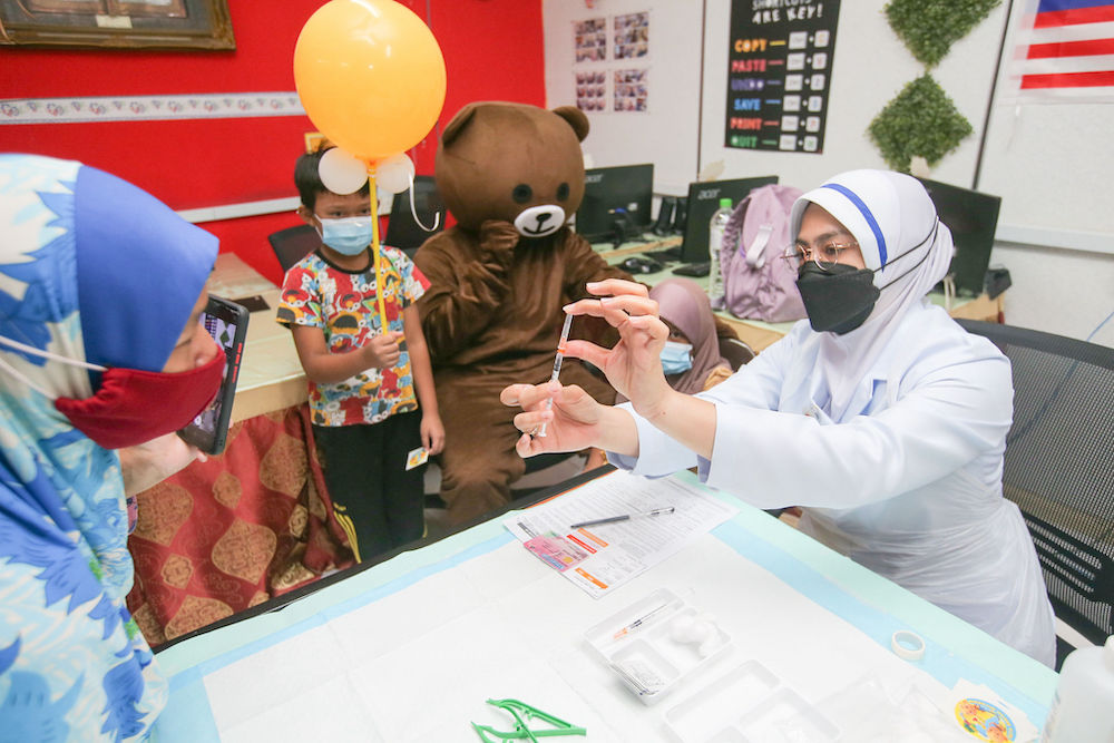 Children get their Covid-19 vaccination at a kindergarten in Parit, Perak February 28, 2022. u00e2u20acu201d Picture by Farhan Najib
