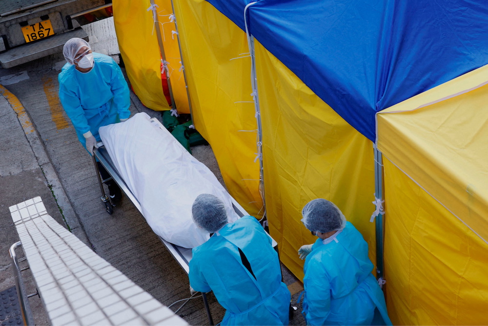 Employees of the funeral home move a body outside a makeshift Covid-19 treatment area, outside a hospital in Hong Kong, China February 27, 2022. u00e2u20acu201d Reuters pic
