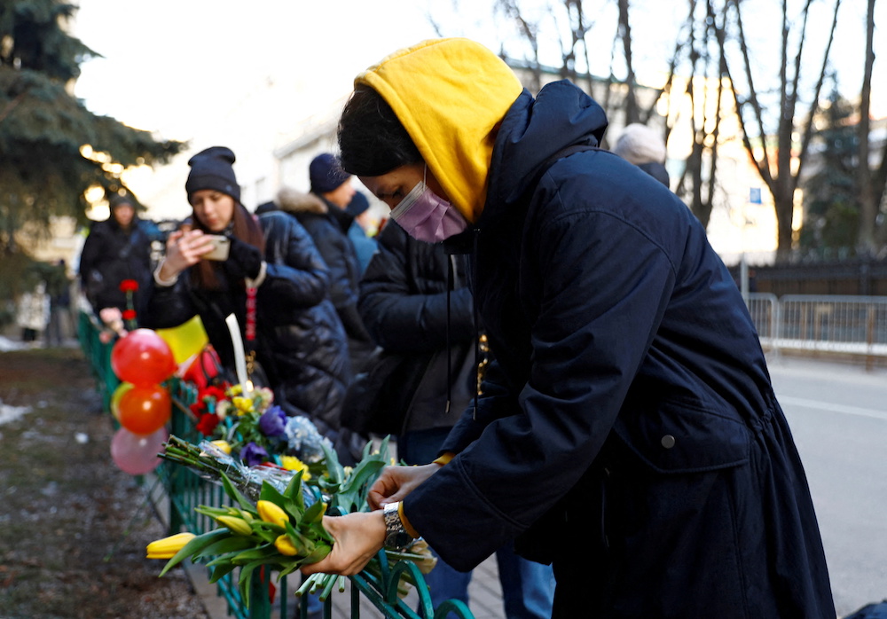 A woman places flowers outside the Ukrainian embassy after Russia launched a massive military operation against Ukraine, in Moscow, Russia February 24, 2022. u00e2u20acu201d Reuters pic