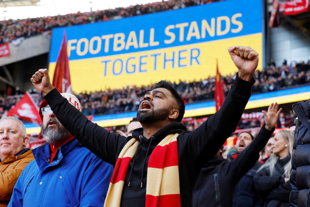 A Liverpool fan is seen with the big screen in the background in support of Ukraine before the Carabao Cup final match between Liverpool and Chelsea, London February 28, 2022. u00e2u20acu201d Action Images via Reuters/John Sibley 