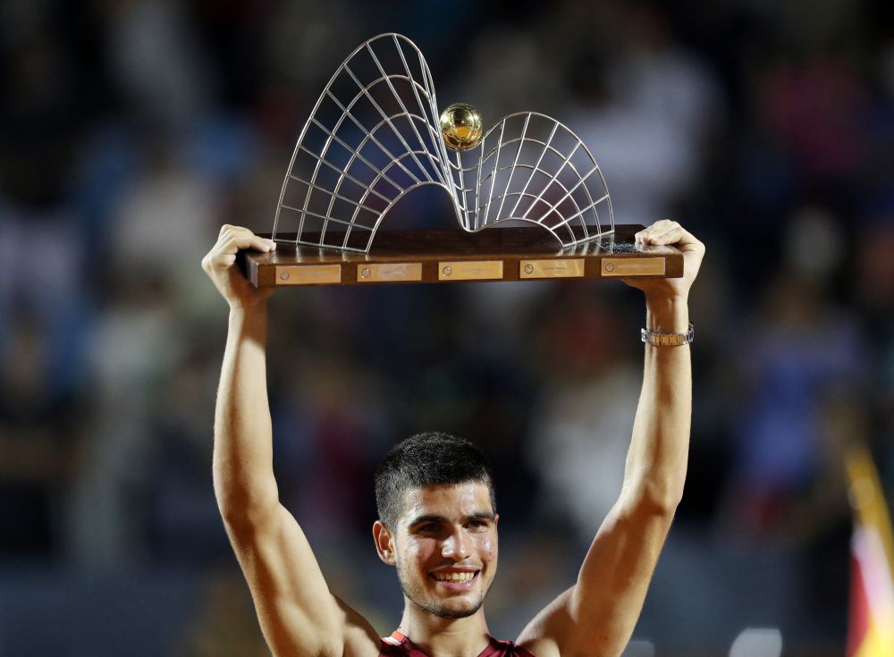 Spain's Carlos Alcaraz celebrates with the Rio Open trophy after beating Argentina's Diego Schwartzman at the Jockey Club Brasileiro, Rio De Janeiro February 20, 2022. u00e2u20acu201d Reuters picnn