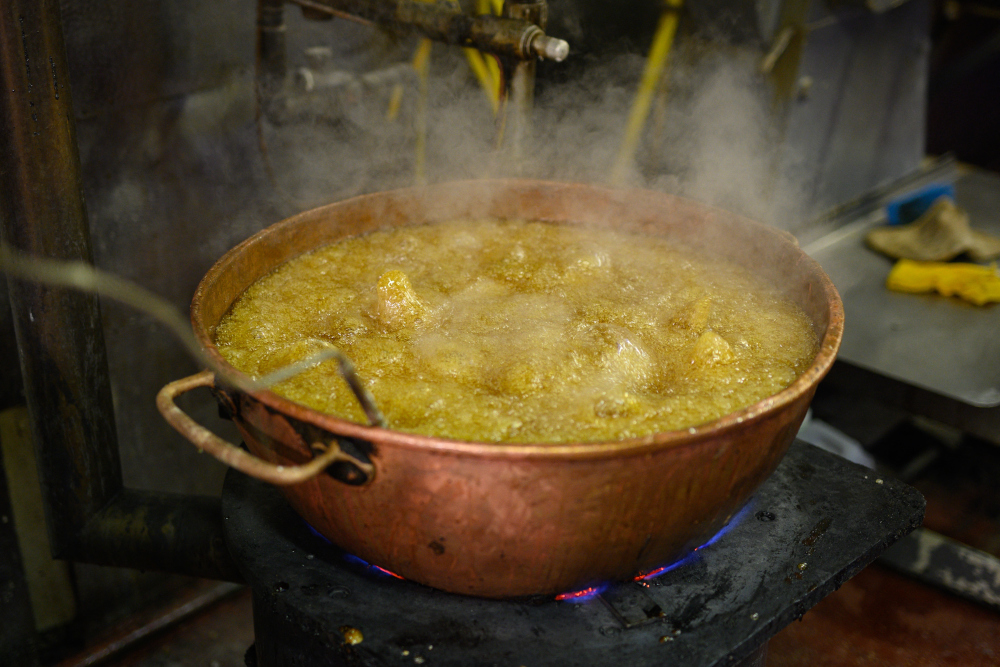 A sugar solution comes to the boil in the traditional sweet manufacturer Edward Grays of Dudley. — AFP pic