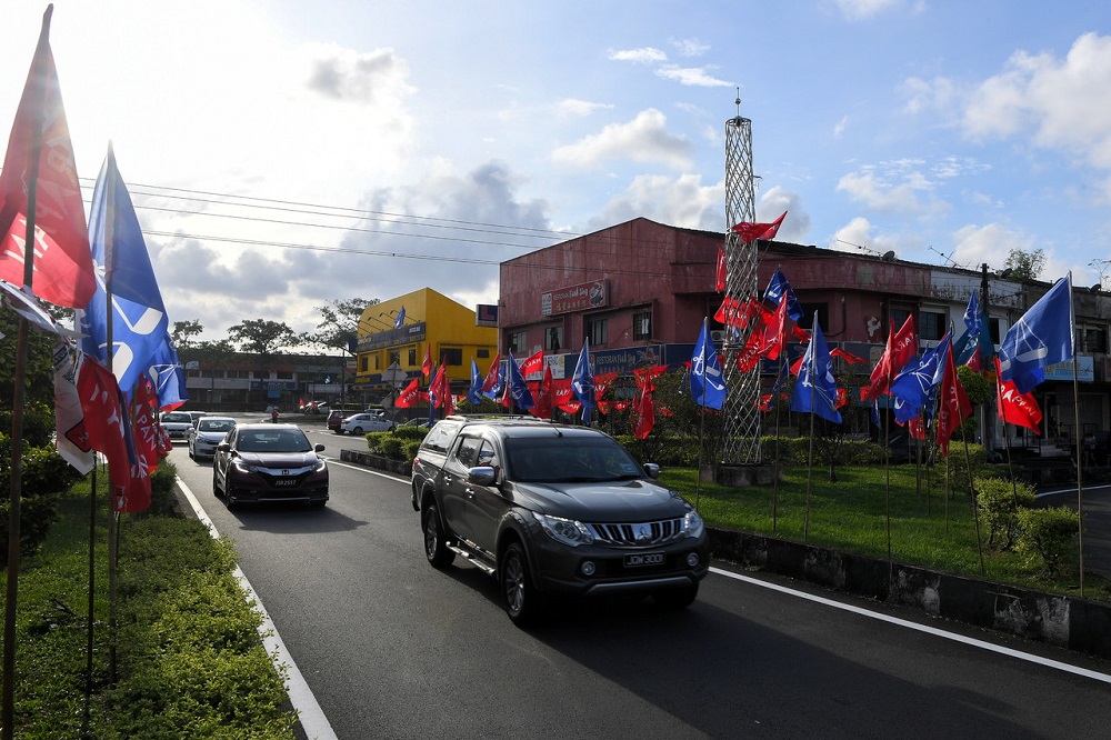 Pakatan Harapan and Barisan Nasional flags line both sides of Jalan Sutera ahead of state elections, in Johor Baru February 28, 2022. — Bernama pic