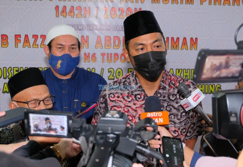 Parti Pesaka Bumiputera Bersatu (PBB) deputy youth chief Fazzrudin Abdul Rahman (right) fielding questions from reporters during a function in Kuching, December 6, 2021. u00e2u20acu201d Borneo Post Online pic 