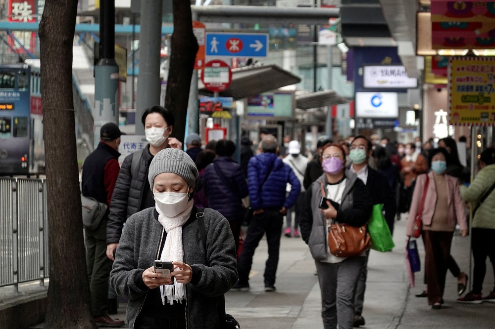 Pedestrians wearing face masks walk on a street at Causeway Bay district in Hong Kong February 9, 2022. u00e2u20acu2022 Reuters pic