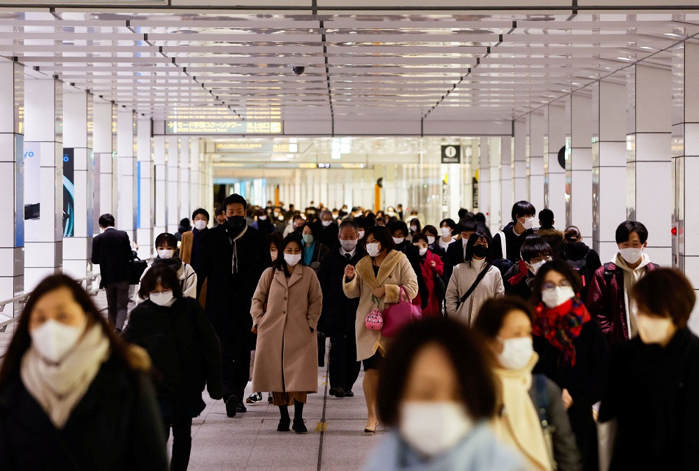 Passersby wearing protective face masks walk at a train station concourse, amid the Covid-19 pandemic, in Tokyo February 9, 2022. u00e2u20acu2022 Reuters pic