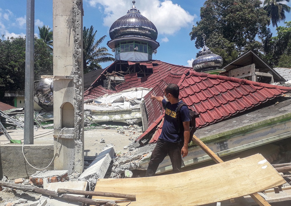 A man checks the damage of the destroyed Raya Kajai mosque after an earthquake in Kecamatan Talamau on Sumatra Island, Indonesia February 25, 2022. u00e2u20acu2022 Antara Foto/Altas Maulana via Reuters
