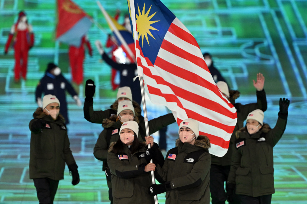 Malaysiau00e2u20acu2122s flag bearers Aruwin Salehhuddin and Jeffrey Webb lead the delegation during the opening ceremony of the Beijing 2022 Winter Olympic Games, at the National Stadium in Beijing, February 4, 2022. u00e2u20acu201d AFP pic 