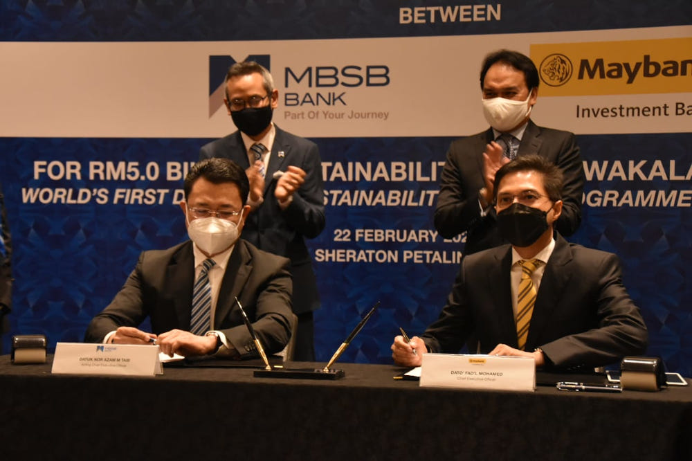 (From left, seated) MBSB Bank acting CEO Datuk Nor Azam M Taib and Maybank Investment Bank CEO Datuk Fad'l Mohamed at the signing ceremony February 22, 2022. u00e2u20acu201d Picture courtesy of MBSB Bank