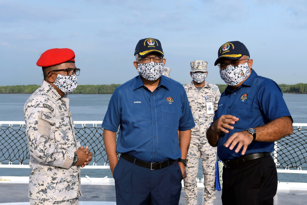 Home Minister Datuk Seri Hamzah Zainudin with MMEA director-general Maritime Admiral Datuk Mohd Zubil Mat Som (left) during MMEAu00e2u20acu2122s 17th anniversary celebration in Selangor waters, Port Klang, February 15, 2022. 