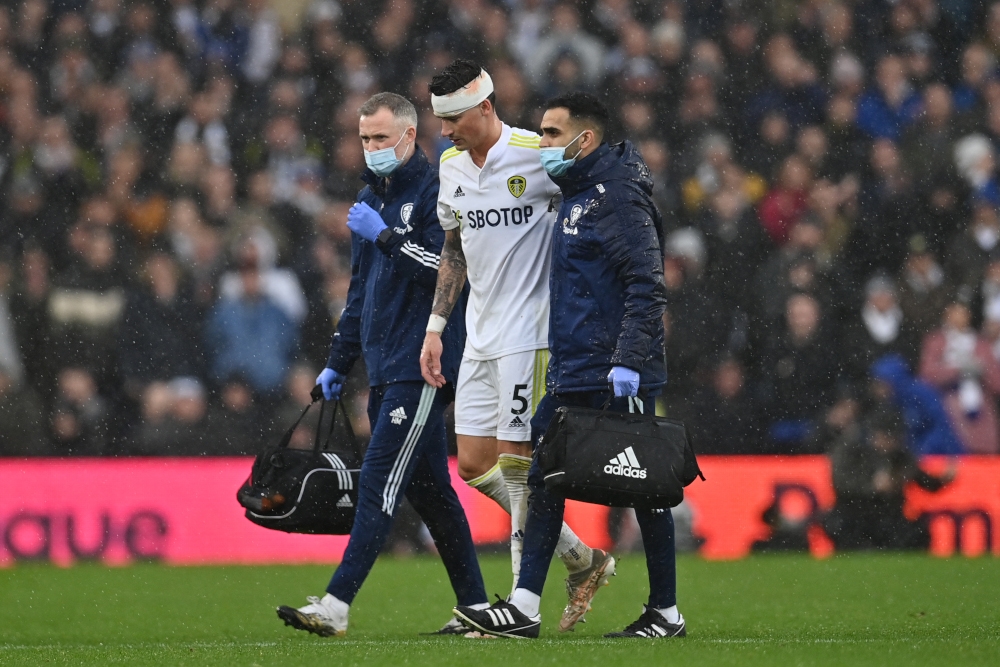 Leeds United defender Robin Koch reacts as he leaves the pitch after receiving medication following a collision with Manchester United midfielder Scott McTominay at Elland Road in Leeds, northern England, February 20, 2022. u00e2u20acu201d AFP picnn