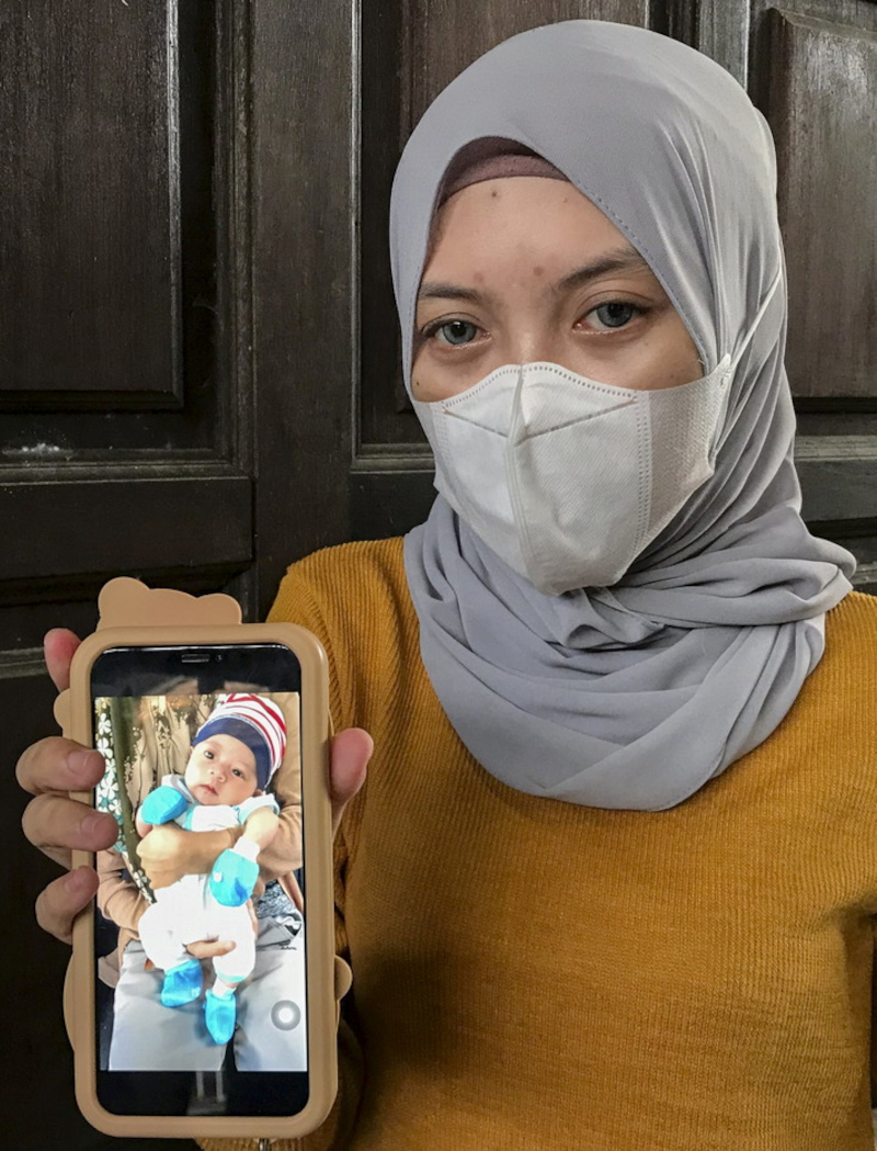 Rosilawati Ismail shows a picture of her late son Muhammad Hilman Firdaus, who died last Friday at the Raja Perempuan Zainab II Hospital in Kota Baru, Kelantan, February 24, 2022. u00e2u20acu201d Bernama pic 