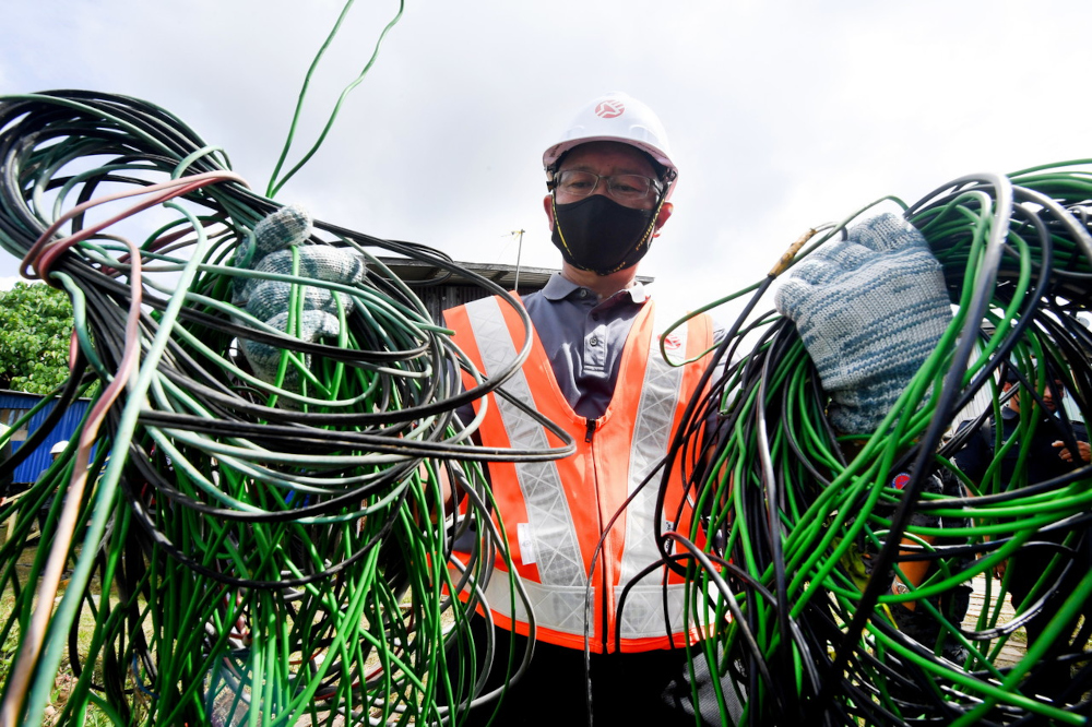 SESB Distribution Division general manager Addie Ahmad with electric cables that were disconnected during an operation in Kampung Di Sayang in Sandakan, Sabah, February 24, 2022. u00e2u20acu201d Bernama pic 
