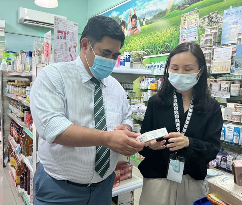 Datuk Shahelmey Yahya looking at a Covid-19 test kit at a pharmacy. u00e2u20acu2022 Borneo Post Online pic 