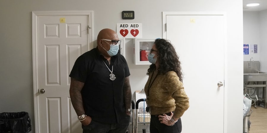Sam Rivera (left), executive director of OnPoint NYC talks to a worker at the newly formed nonprofit that operates a overdose prevention centre in the Harlem borough of New York. u00e2u20acu2022 ETX Studio picnn
