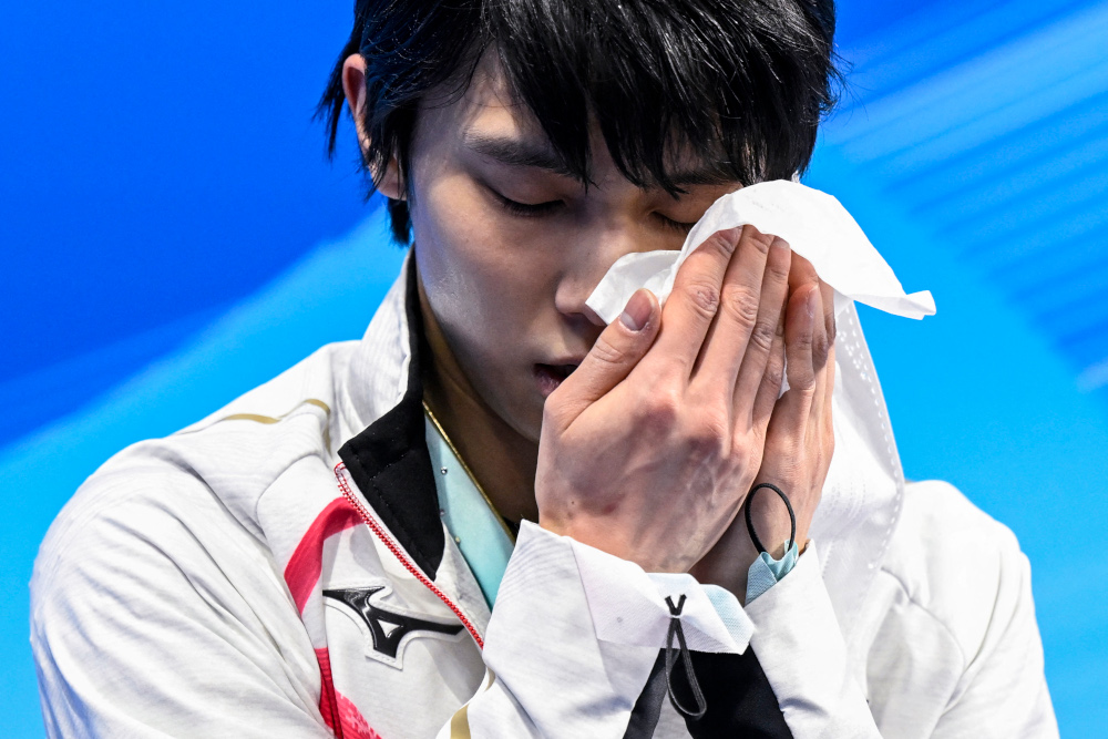 Japanu00e2u20acu2122s Yuzuru Hanyu wipes his face after competing in the menu00e2u20acu2122s single skating free skating of the figure skating event during the Beijing 2022 Winter Olympic Games at the Capital Indoor Stadium in Beijing, February 10, 2022. u00e2u20acu201d AFP pic 