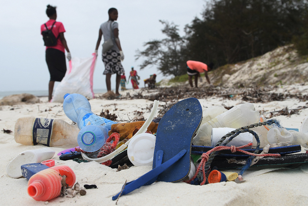 Volunteers collect plastic waste during a cleaning exercise organised by Ocean Sole Africa, in Kilifi county. u00e2u20acu201d AFP pic 