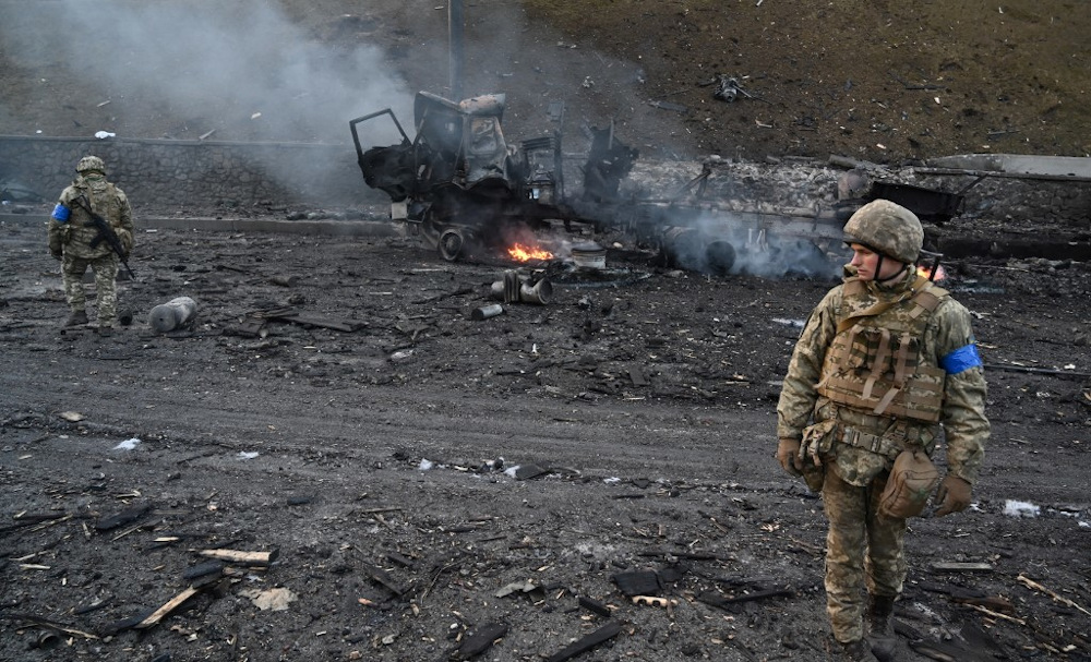 Ukrainian service members look for unexploded shells after a fighting with Russian raiding group in the Ukrainian capital of Kyiv in the morning of February 26, 2022, according to Ukrainian service personnel at the scene. u00e2u20acu201d AFP pic
