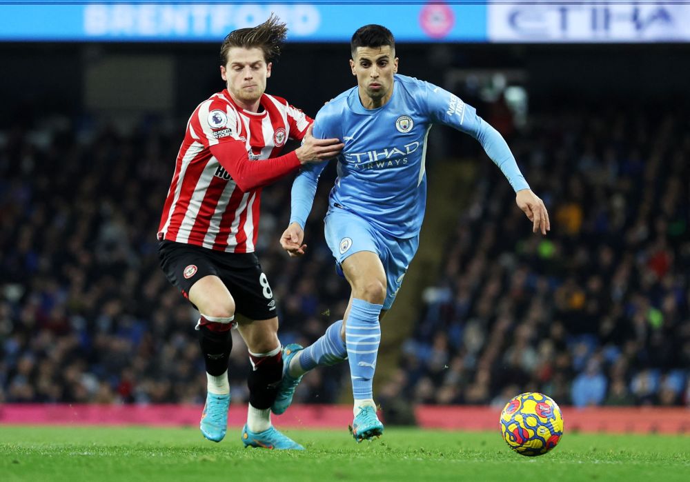 Manchester City's Joao Cancelo in action with Brentford's Mathias Jensen at the Etihad Stadium, Manchester February 9, 2022. u00e2u20acu201d Reuters pic