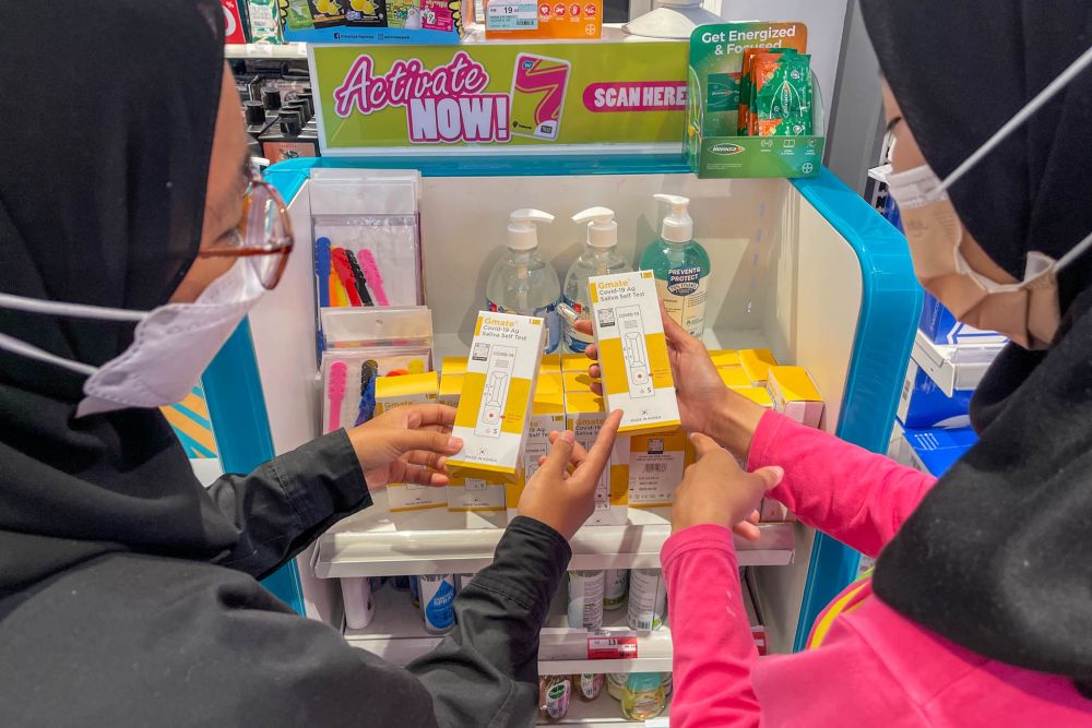 People shop for Covid-19 self-test kits at a Watsons outlet in Bandar Baru Selayang February 22, 2022. u00e2u20acu201d Picture by Hari Anggara