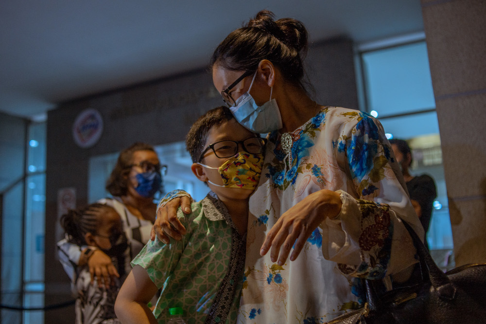 Adlyn Adam Teoh with her son waiting for his Malaysian citizenship certificate to be approved by the National Registration Department in Putrajaya, February 21, 2022. u00e2u20acu201d Picture by Shafwan Zaidon