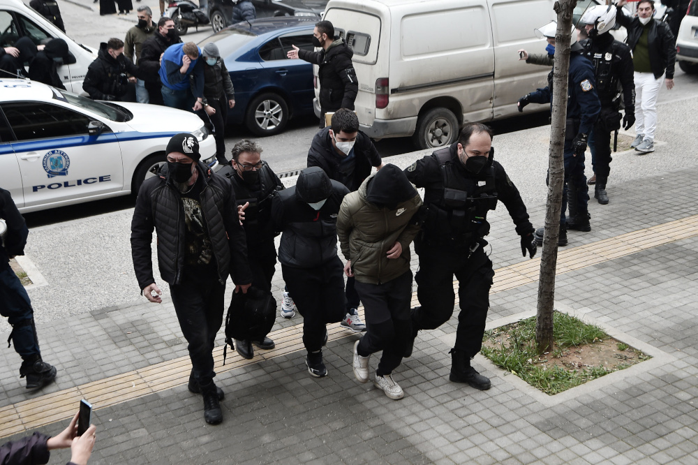 Suspects escorted by police officers arrive for a hearing before prosecutors for the attack outside the Aris FC stadium, in Thessaloniki, February 7, 2022. u00e2u20acu2022 AFP pic 