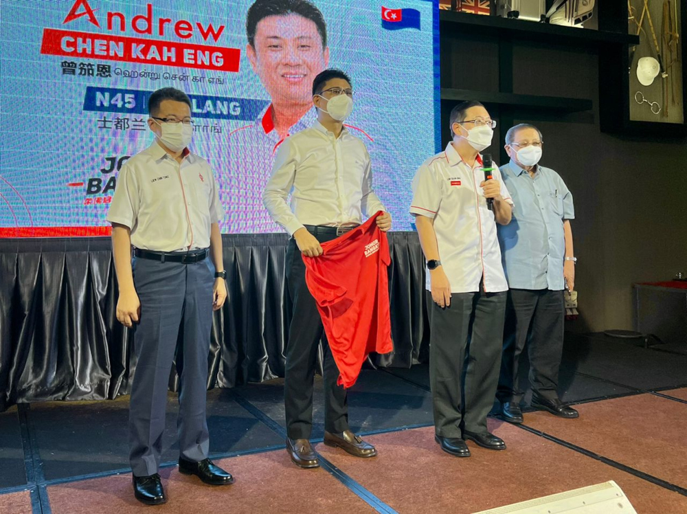 DAP secretary-general Lim Guan Eng announcing Andrew Chen Kah Eng (2nd left) as candidate to defend his Stulang seat during a dinner event held at Cathay Restaurant in Stulang Laut, Johor Baru, February 18, 2022. u00e2u20acu201d Picture by Ben Tan