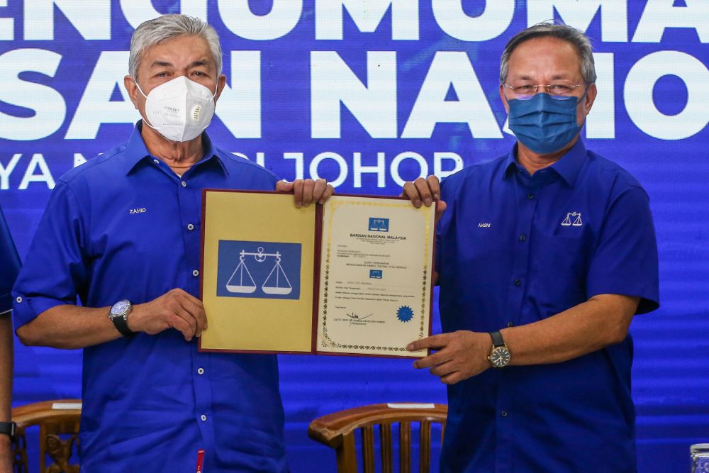 Datuk Seri Ahmad Zahid Hamidi and Datuk Hasni Mohammad pose for the camera during an event to announce Barisan Nasionalu00e2u20acu2122s candidates for the Johor state poll in Johor Baru February 24, 2022. u00e2u20acu201d Picture by Hari Anggara